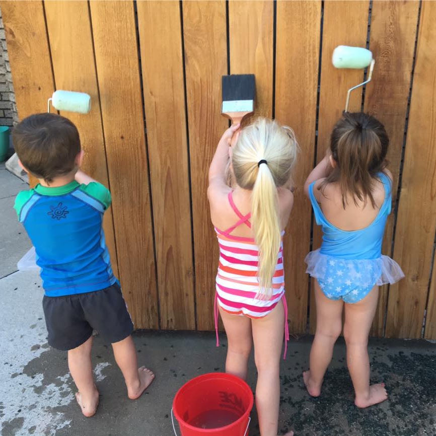 kids painting a fence