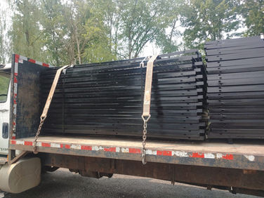 Metal fabrication strapped onto a truck flat bed