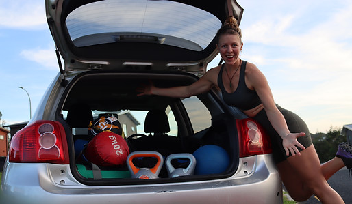car with exercise equipment and person standing next to car