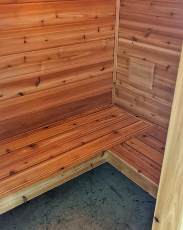 Custom cedar sauna built in a home gym.