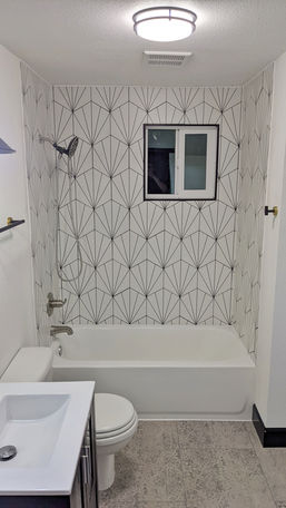 Custom tile shower remodel with updated tub, fixture, and a new window. 