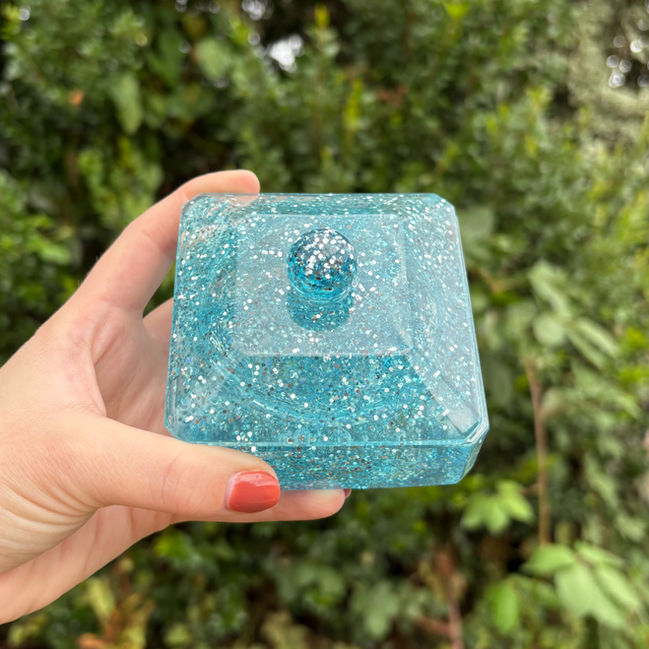 Transparent blue resin storage pot with glitter accents