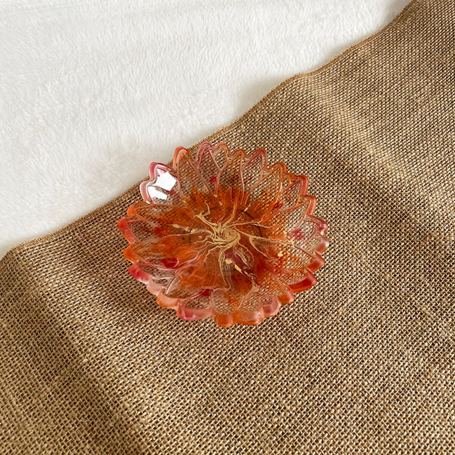 Floral resin bowl with transparent base and vibrant orange edges