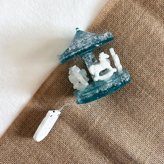 Resin carousel with silver and white shimmer horses and built-in lights