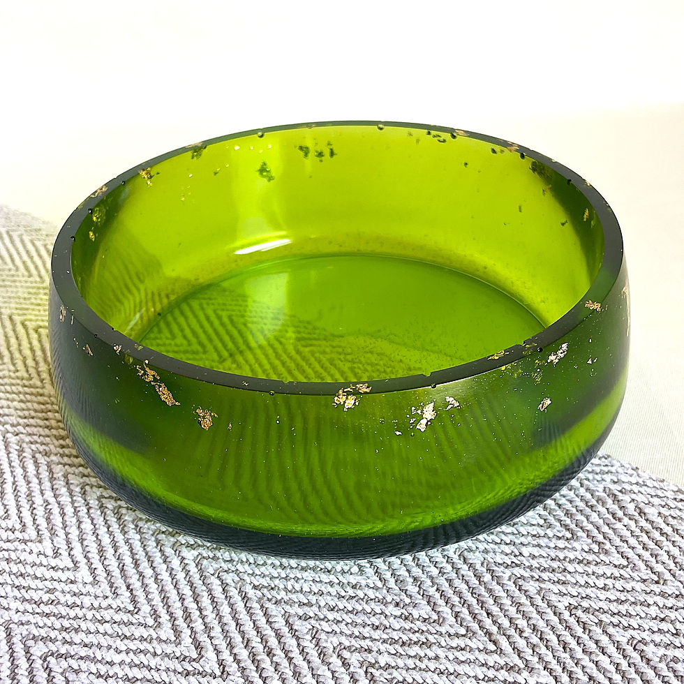 Decorative resin catchall bowl in translucent green with embedded gold leaf