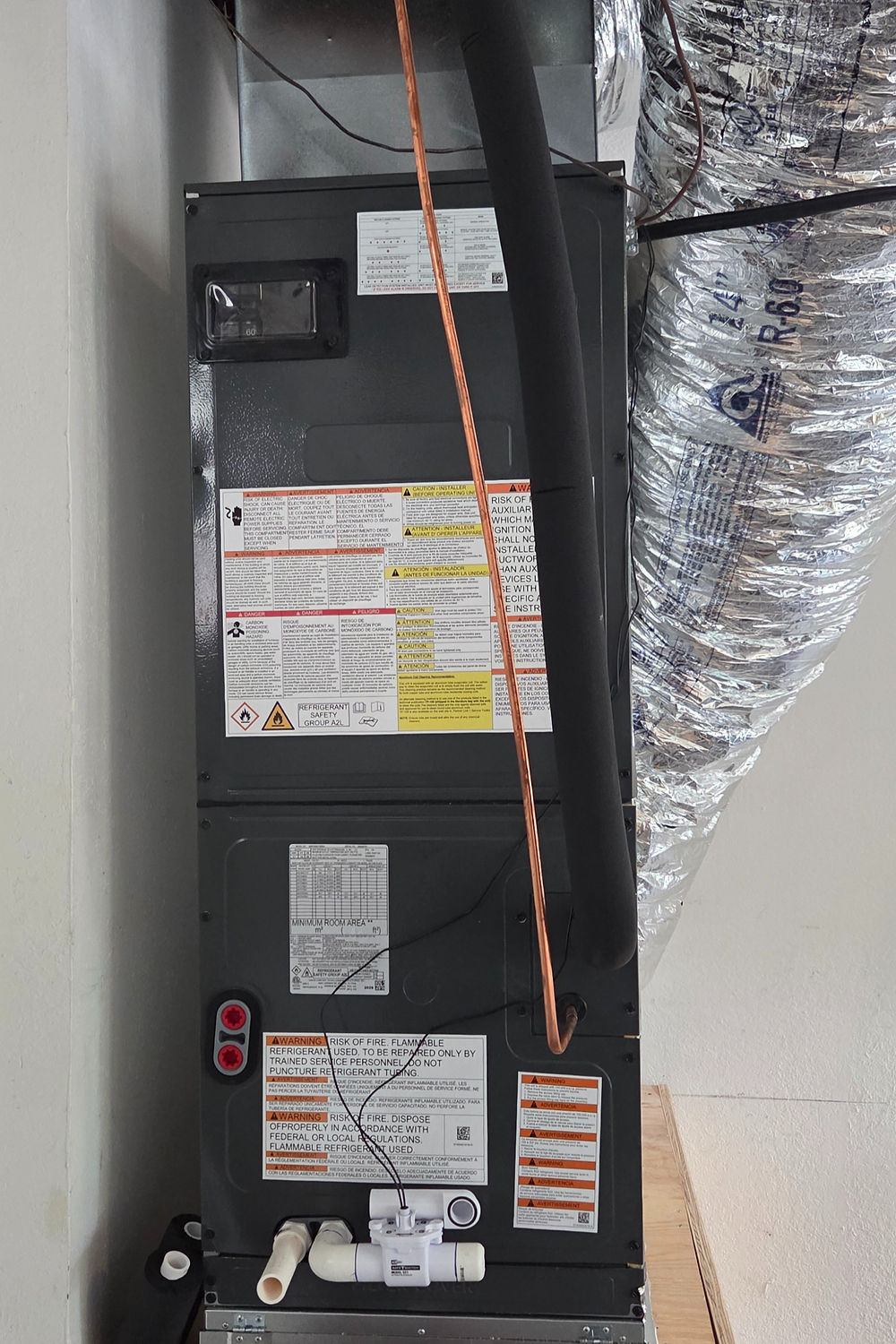 Modern indoor HVAC unit with ductwork in a utility room