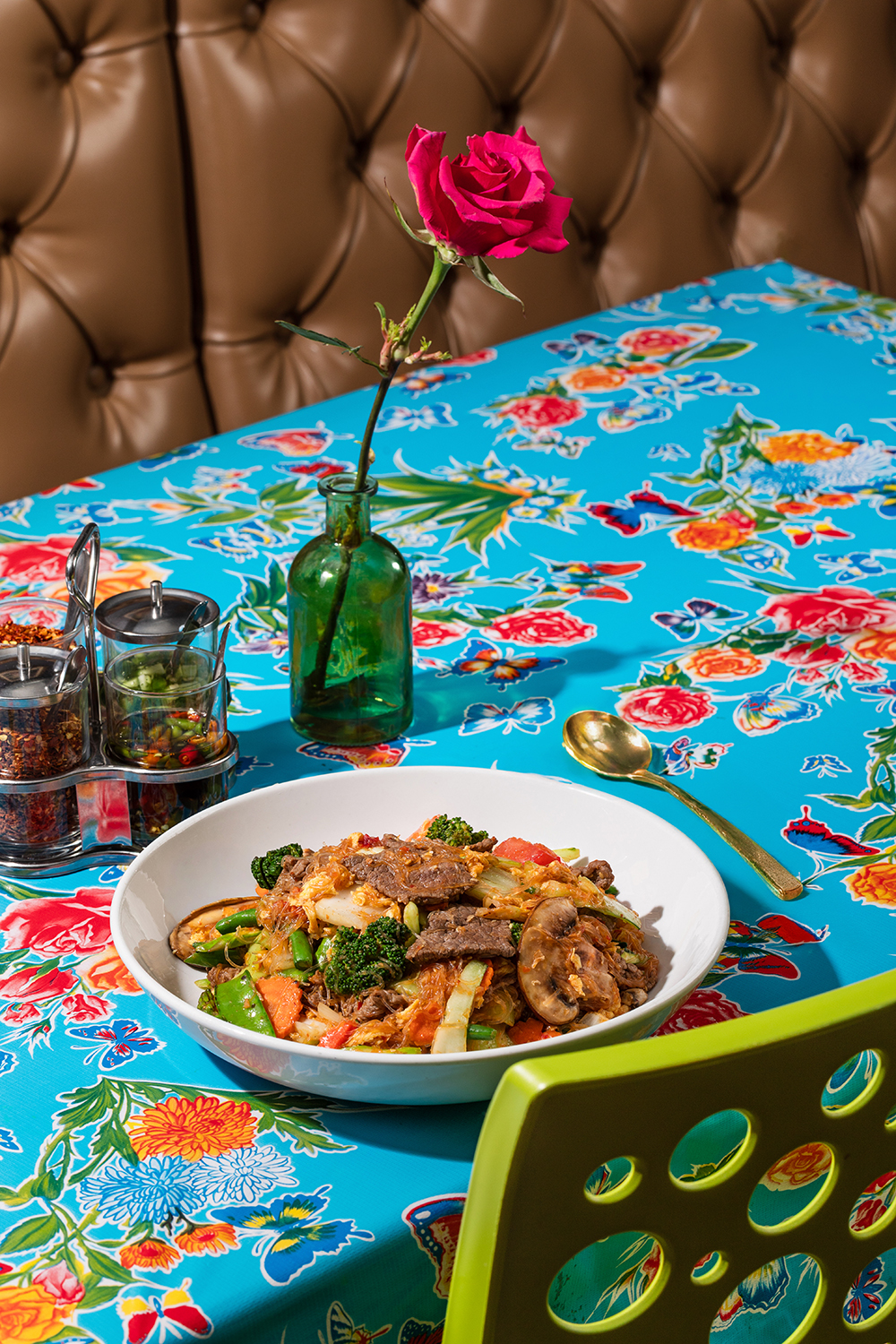“Colorful restaurant table setting with plated dish and drinks.”