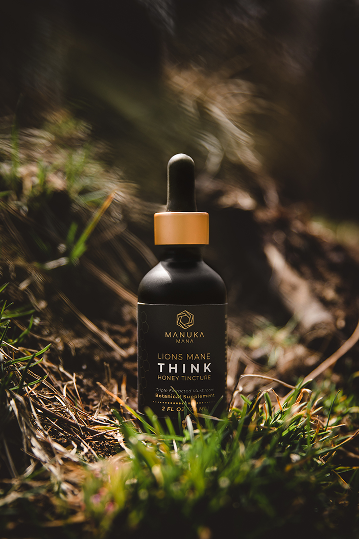 “Dark glass dropper bottle product photographed outdoors in natural light.”