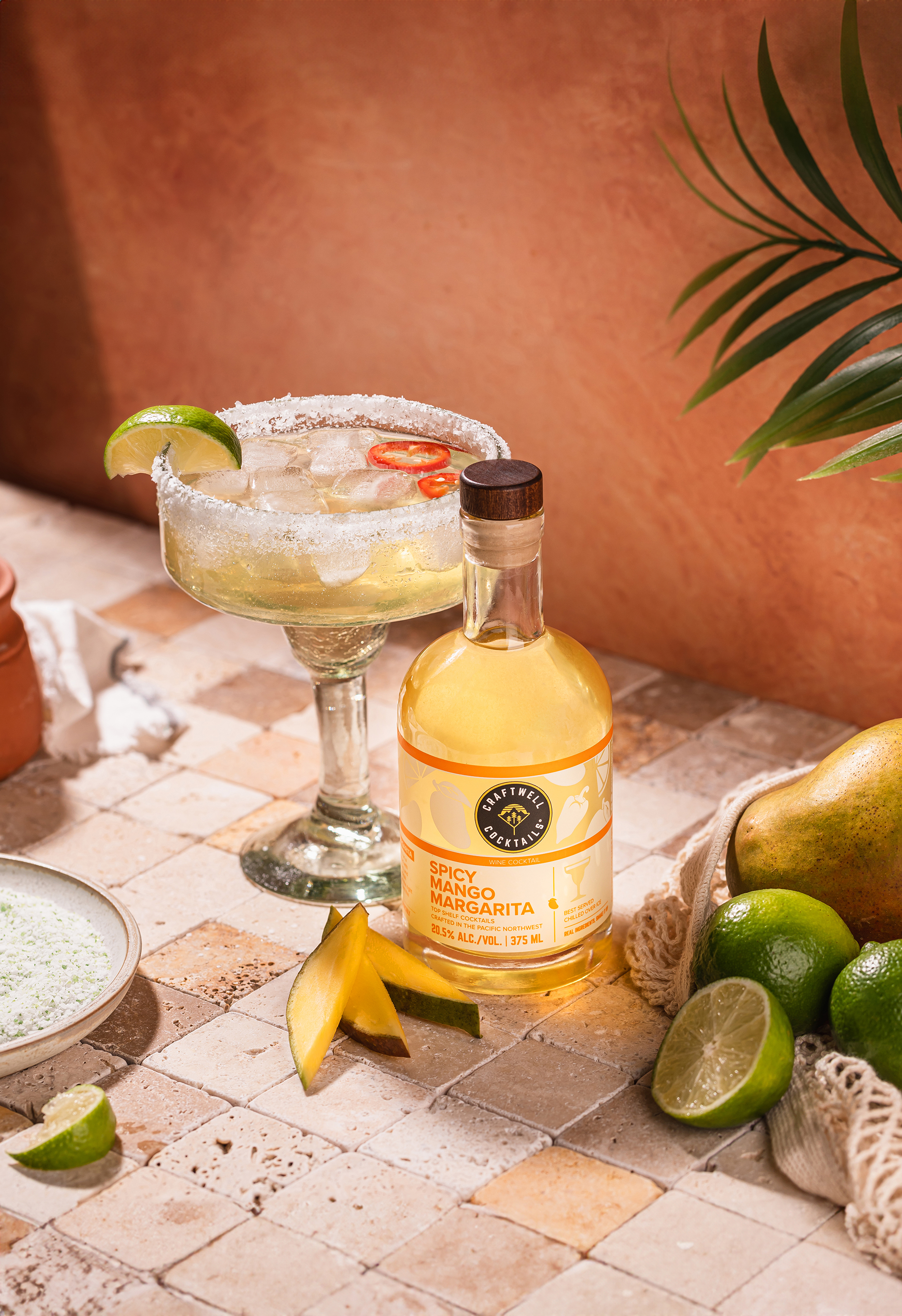 “Canned cocktail with salt-rimmed drink on a sunlit tabletop with limes.”