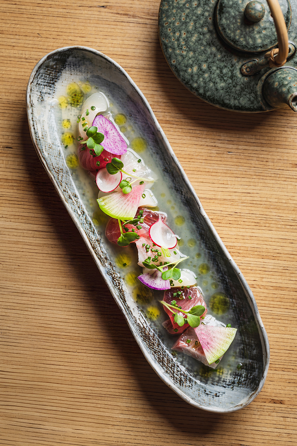 “Long plated dish with colorful toppings, overhead shot.”