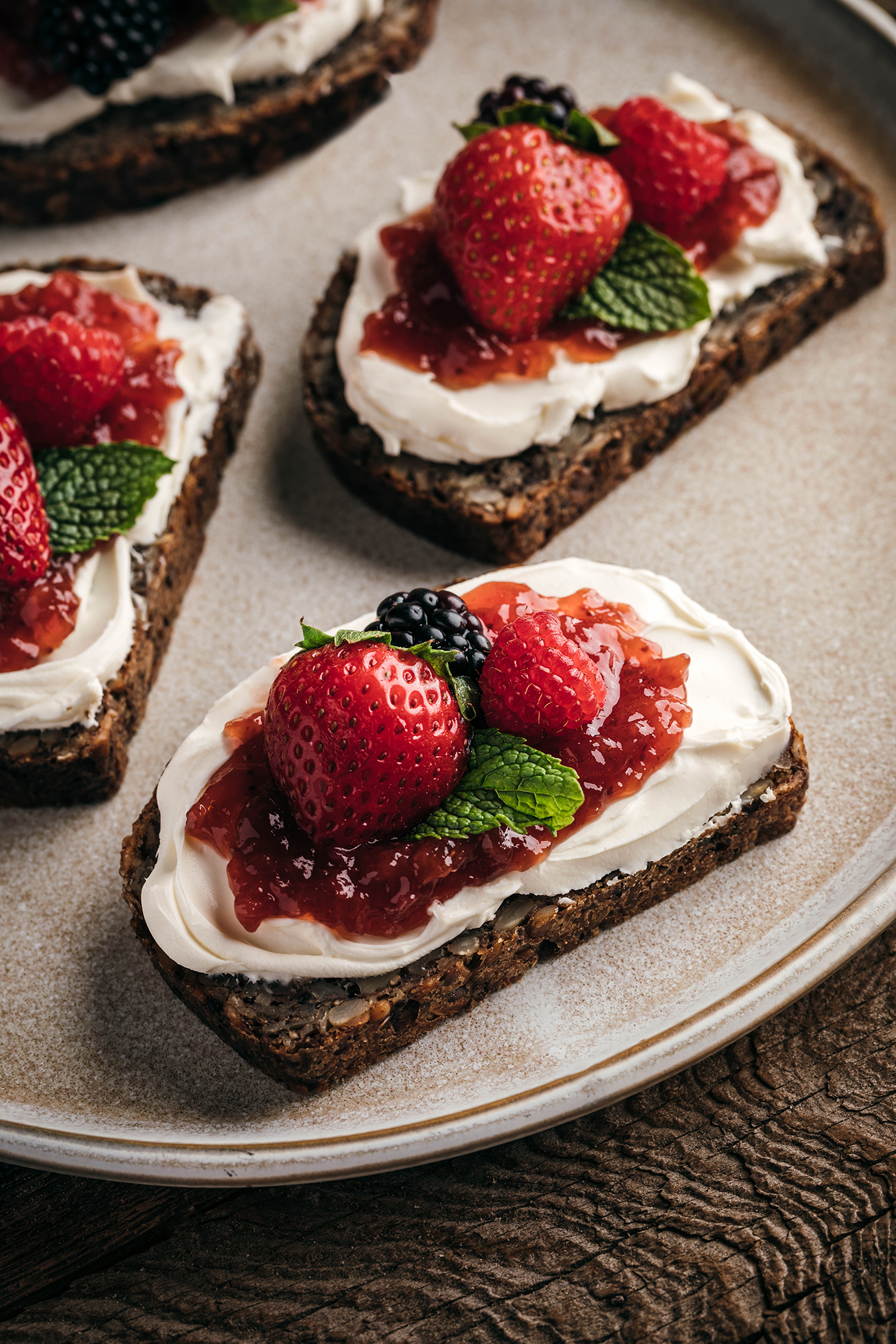 “Toast with whipped topping and fresh berries on a plate, food close-up.”