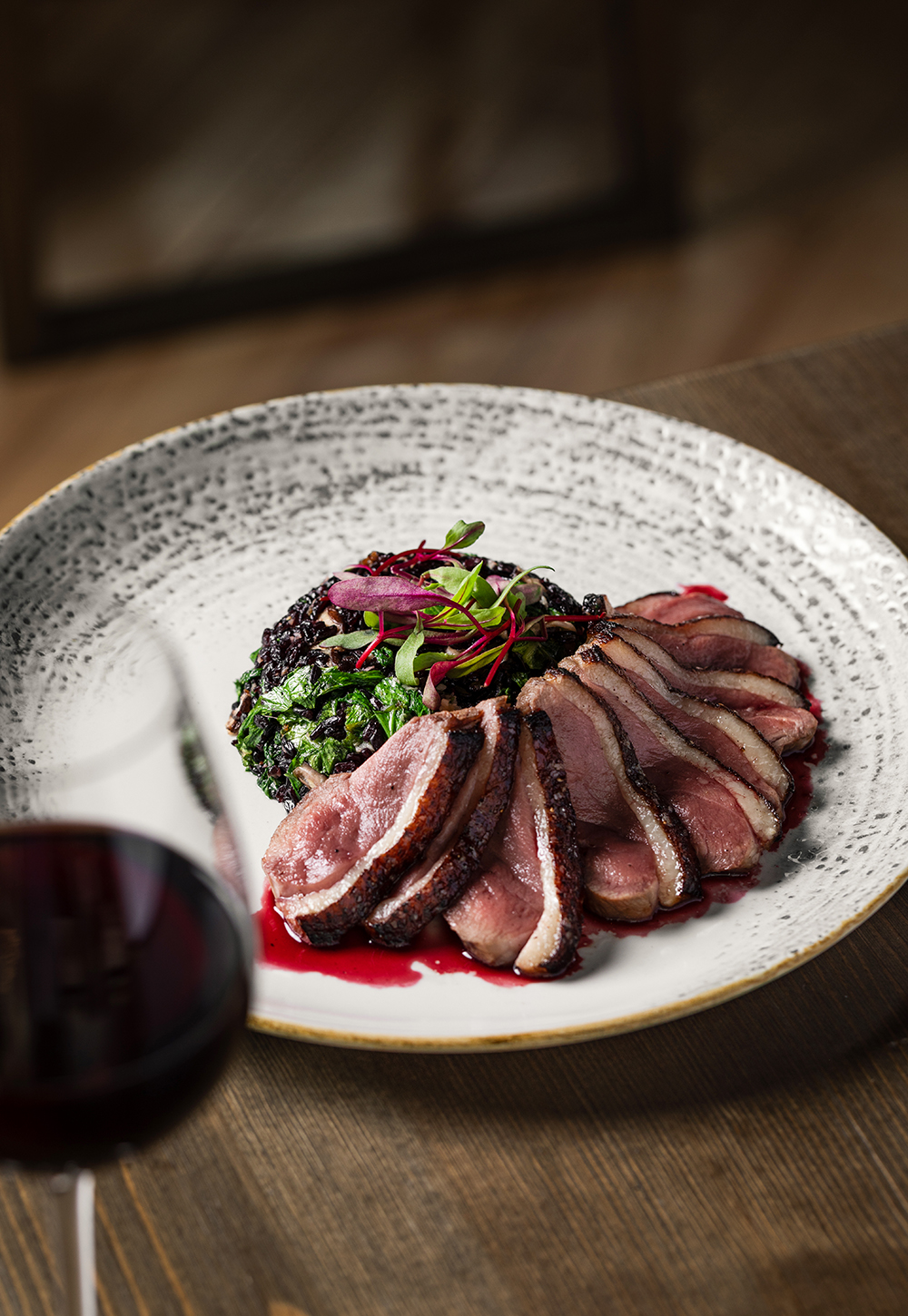 “Sliced steak plated with sauce and garnish, overhead food shot.”