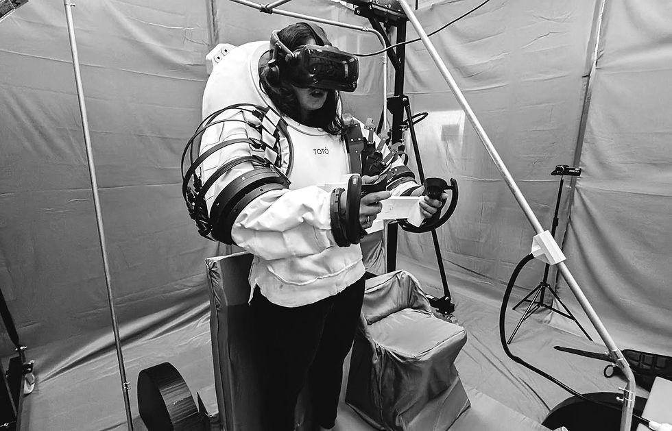 A test subject wearing a space suit mockup and a VR headset on for testing a prototype of the lunar terrain vehicle. 