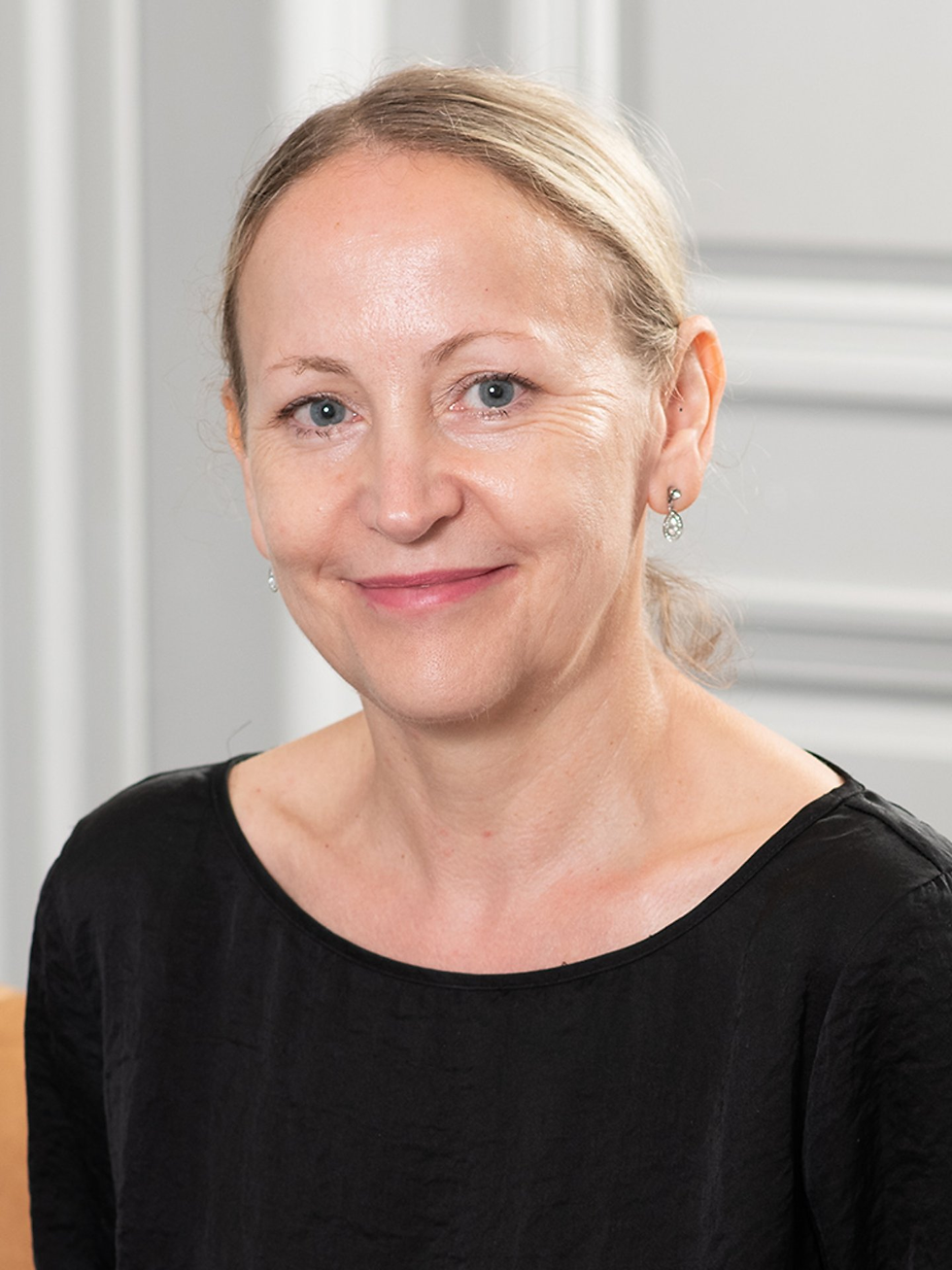 Headshot of a woman with blonde hair and a gentle smile.