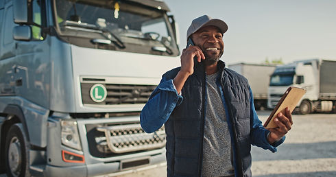 African American man speaking on phone with his coworker or customer while holding tablet