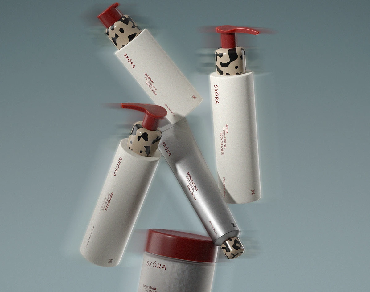 Skora bodycare packaging featuring minimalist bottles and pumps floating in motion, with off-white textured labels, astaxanthin-inspired red accents, and sculptural patterned caps, presented in a refined, editorial composition.