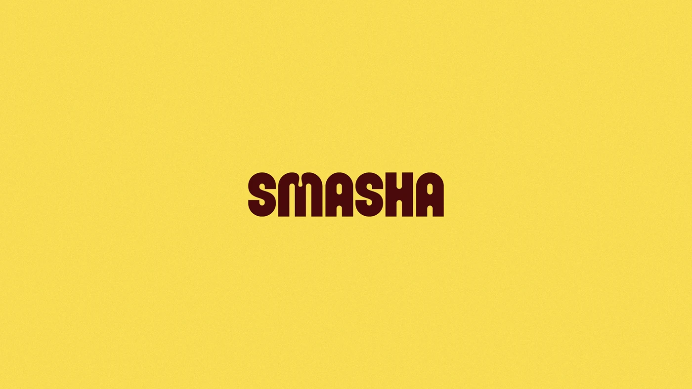 Smasha wordmark centered on a bold yellow background, highlighting the burger restaurant’s modern typography and high-impact brand identity.
