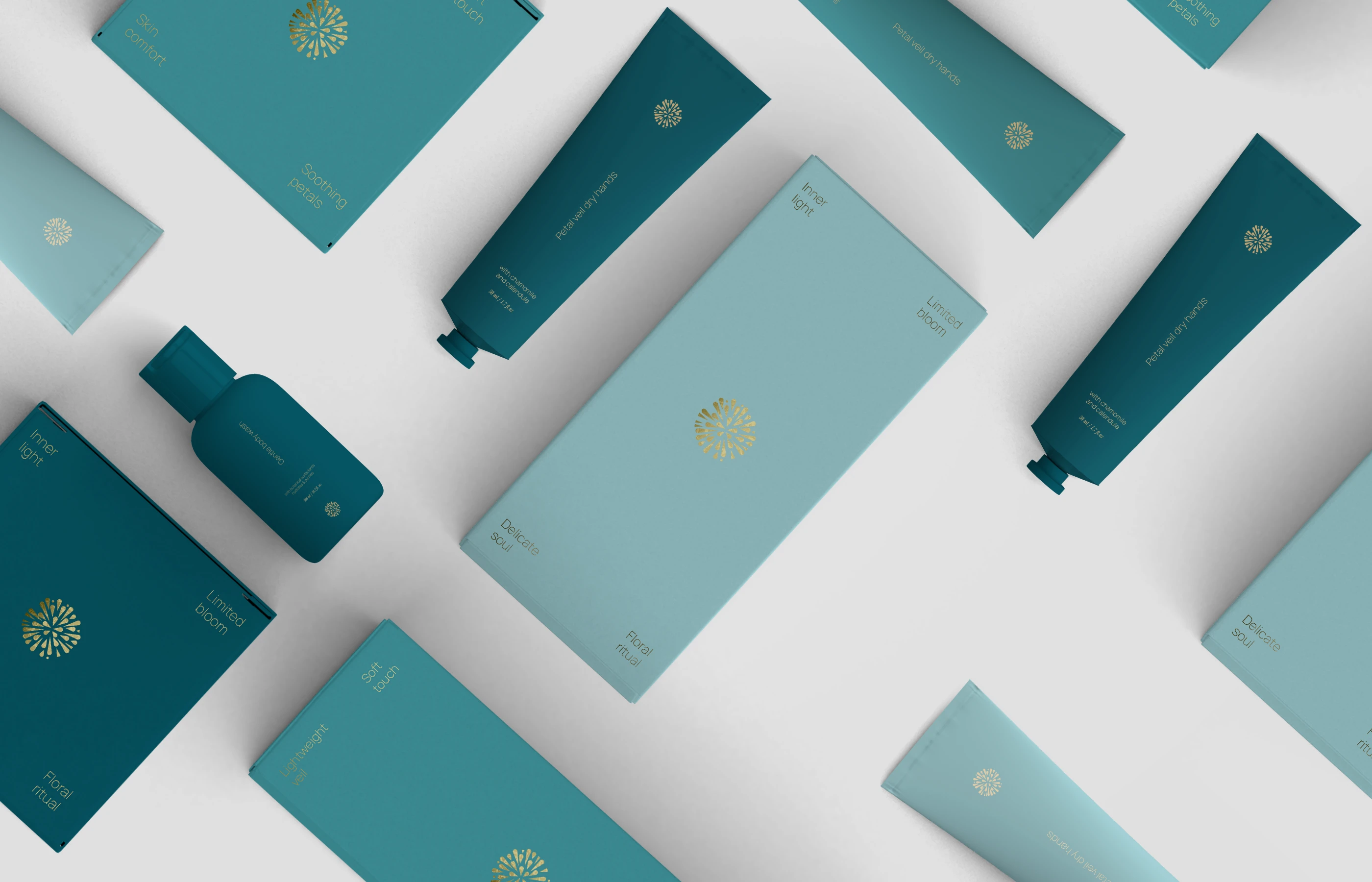 An overhead flatlay of diverse Lumere skincare products arranged in a diagonal pattern on a clean grey surface. Includes matte teal tubes, a small pump bottle, and rectangular boxes featuring gold mandala logos and sharp white serif typography.