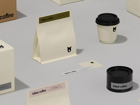 Lubear Coffee minimalist packaging and brand materials by taoSTUDIO, featuring a cream coffee bag, takeaway cup, black coffee tin, labels, boxes, and small moon bear icon.