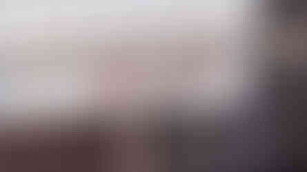 Pluto Coffee + Art Café handwritten logo printed on a blue and cream striped awning as part of the café exterior branding.