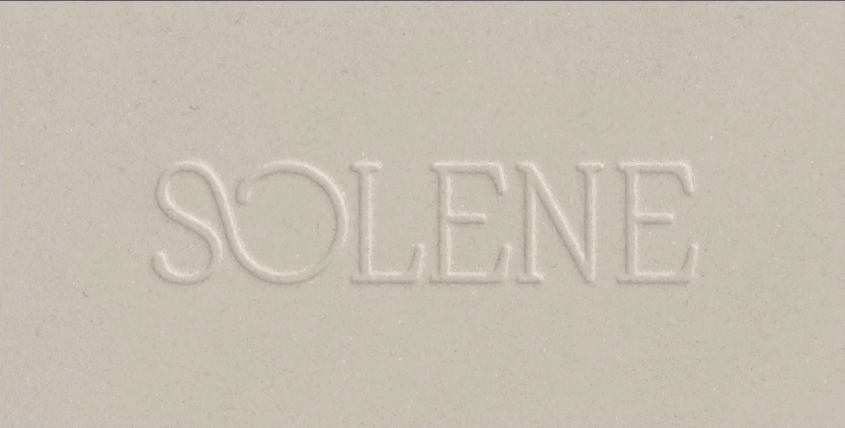 Close-up of blind embossed Solene logo on textured ivory packaging, showing the tactile luxury detail used in the SPF sunscreen brand identity and packaging system.