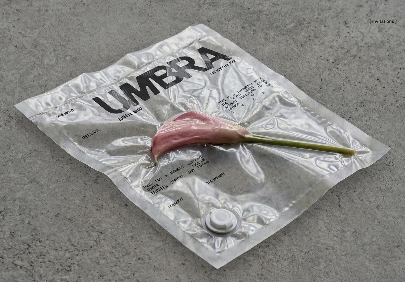 UMBRA invitation design featuring a pink calla lily sealed inside a translucent vacuum-style pouch with bold black branding and minimal typography on a concrete surface.
