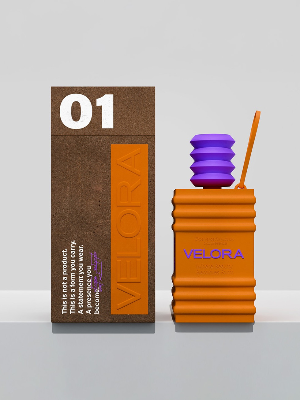A textured brown Velora box marked “01” stands beside a golden orange sculptural vessel with a purple cap, presented against a light gray background.