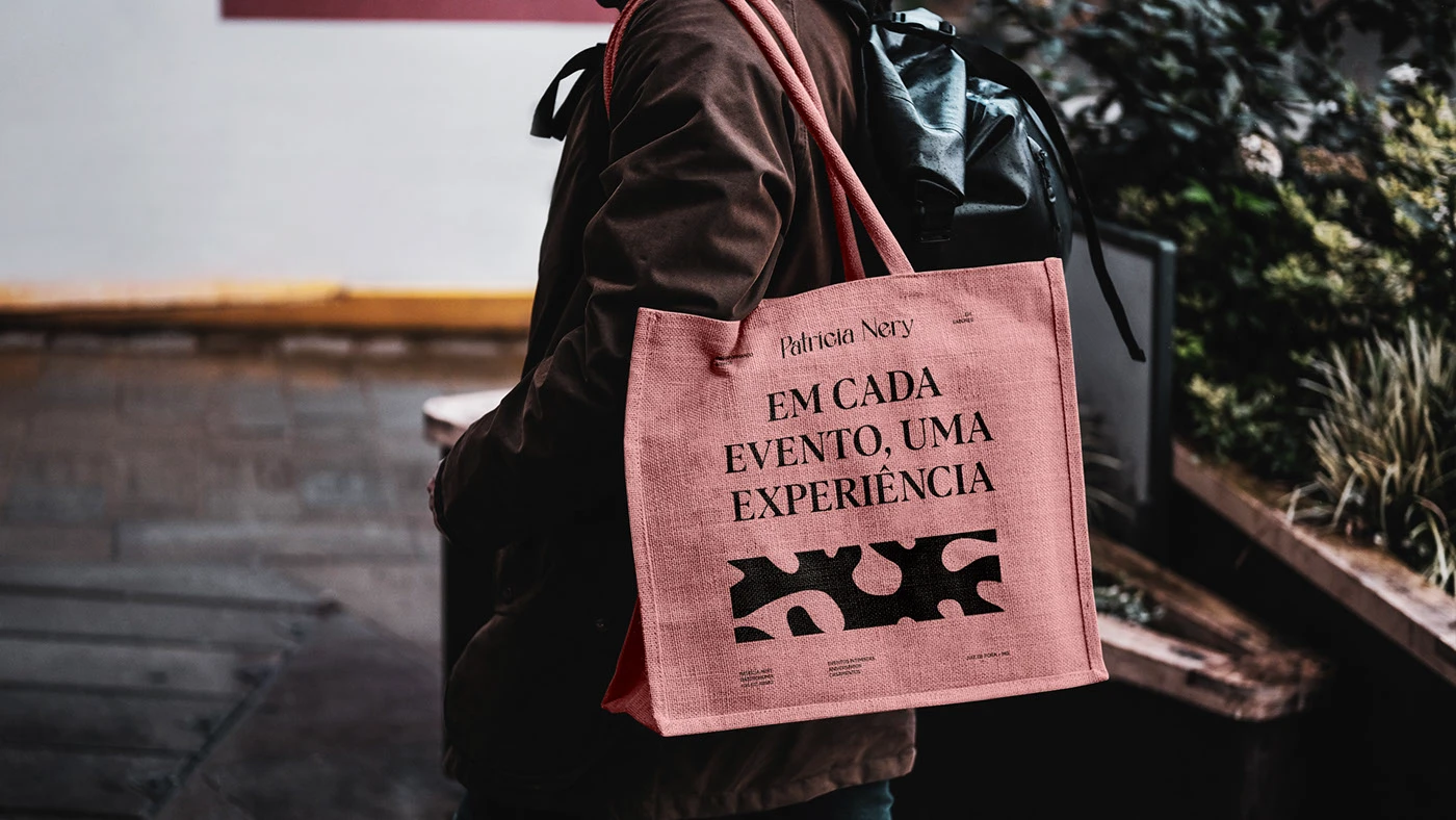 Patricia Nery culinary brand identity tote bag in pink with editorial typography and organic black pattern, showcasing modern event-driven chef branding.