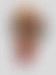 Two textured Velora packaging boxes float in a dynamic suspended composition, revealing bold orange and red vessels with sculptural caps and large typographic branding.