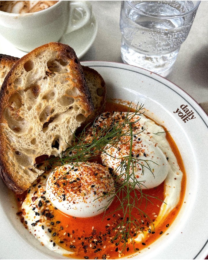 Daily Yolk brunch food photography showing soft eggs, toasted bread, and branded plate styling that reflects the café’s warm, modern identity.