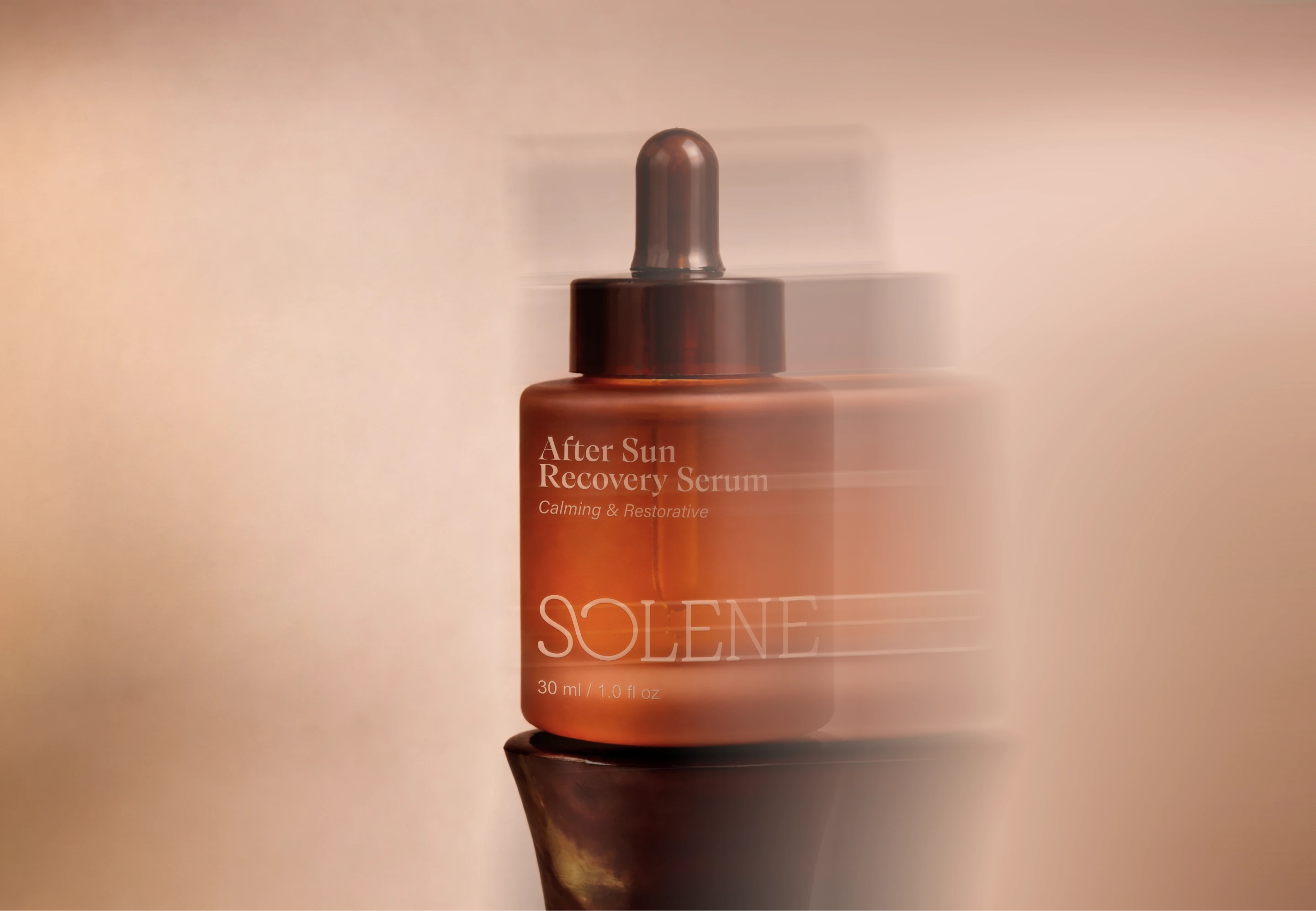 Solene SPF after sun recovery serum in warm amber packaging with soft motion blur, highlighting the refined skincare brand identity and sun care packaging design.