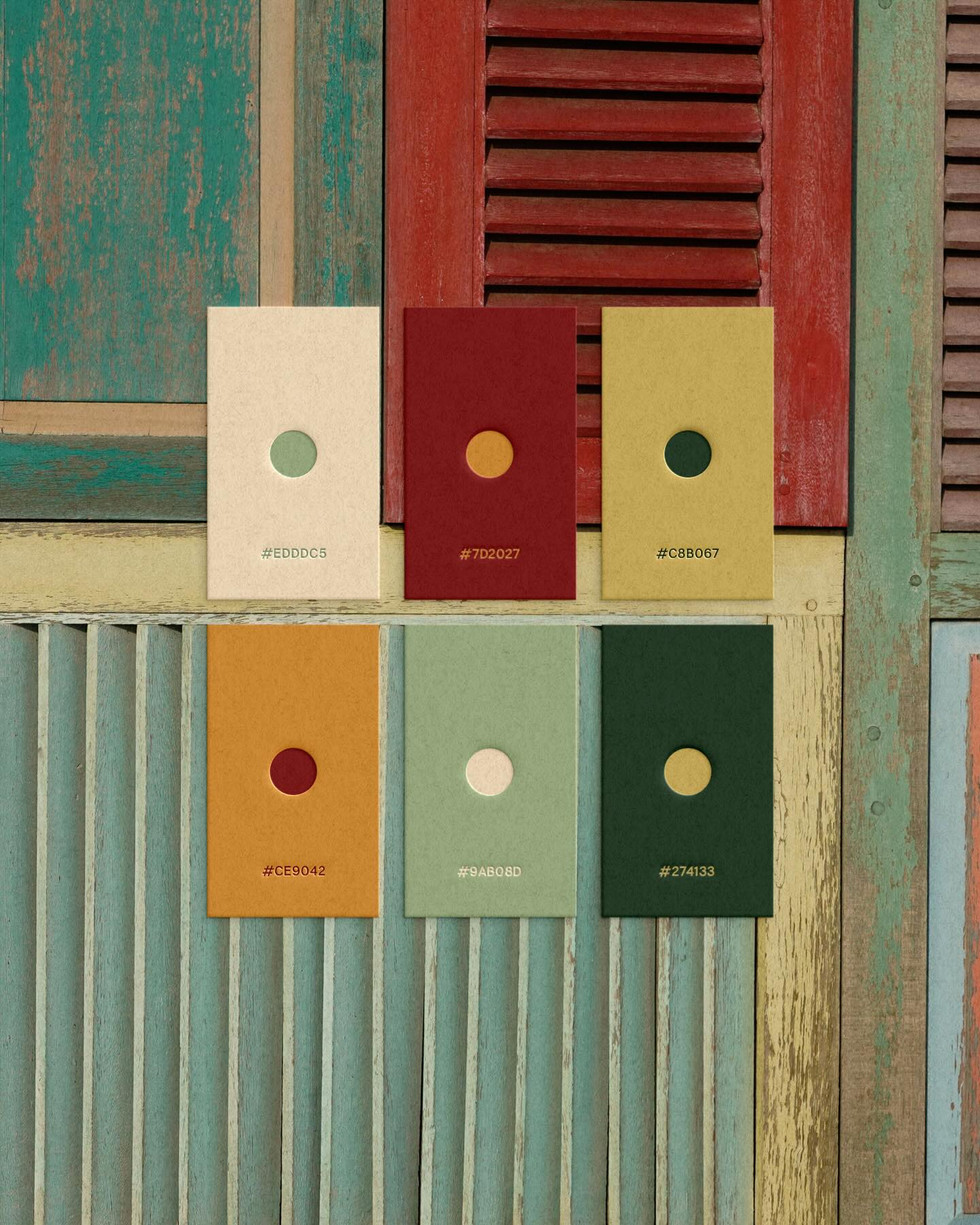 Red Dahlia color palette titled Streets of Old, featuring muted red, cream, ochre, sage green, and deep forest green swatches over weathered painted wood siding.