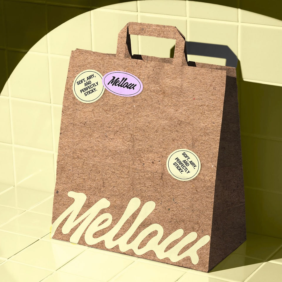 Brown kraft paper shopping bag with playful Mellow branding and circular stickers designed by WOORI STUDIOS™. The design combines handcrafted warmth with pastel details, embodying sustainable modern branding.