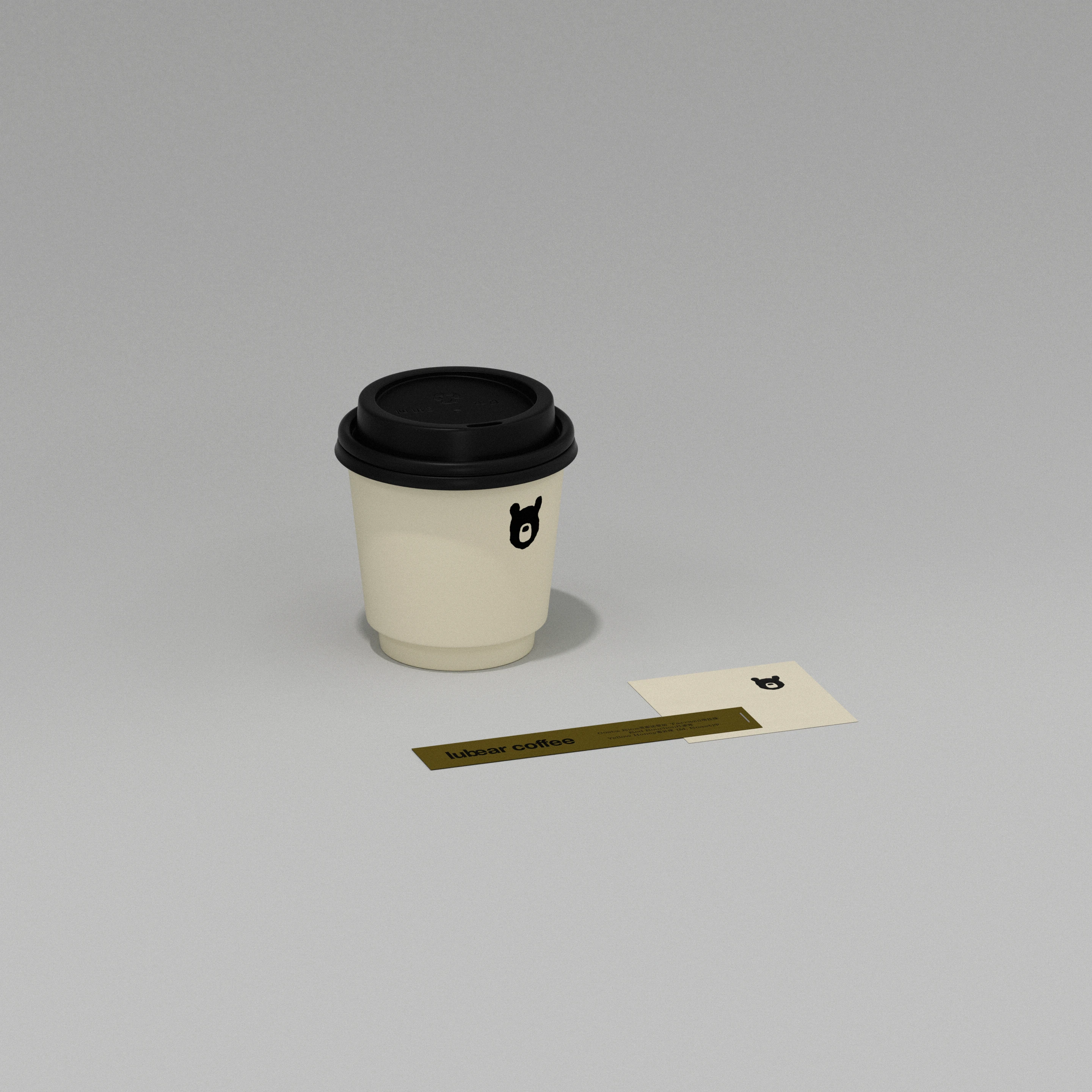 Lubear Coffee takeaway cup and printed labels with moon bear icon, showing the minimalist coffee branding system’s warm neutral palette and quiet packaging restraint.