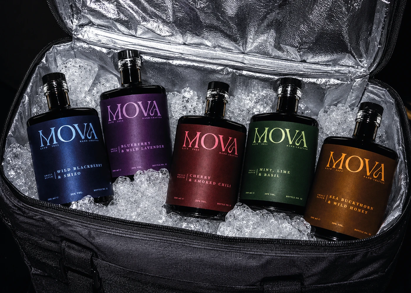 Five MOVA fruit liqueur bottles with colorful minimalist labels arranged in a cooler filled with crushed ice.