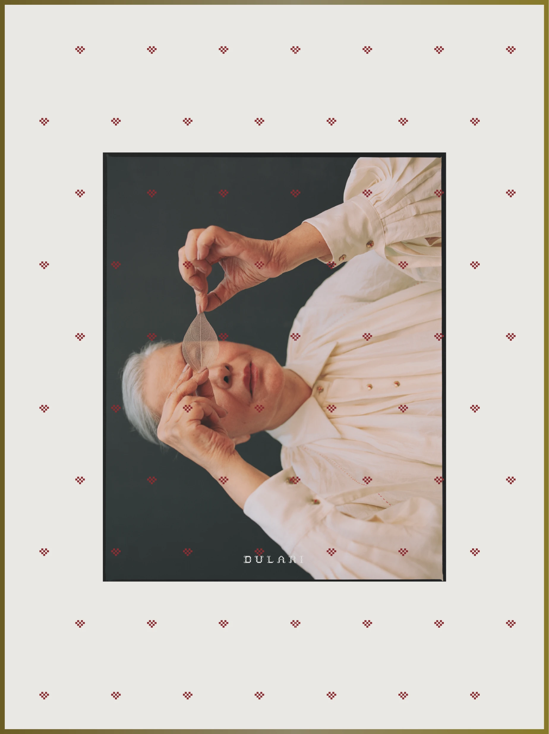 Dulari fashion brand identity editorial portrait framed by repeating pixel heart pattern, showcasing restrained typography and heritage-inspired visual system.