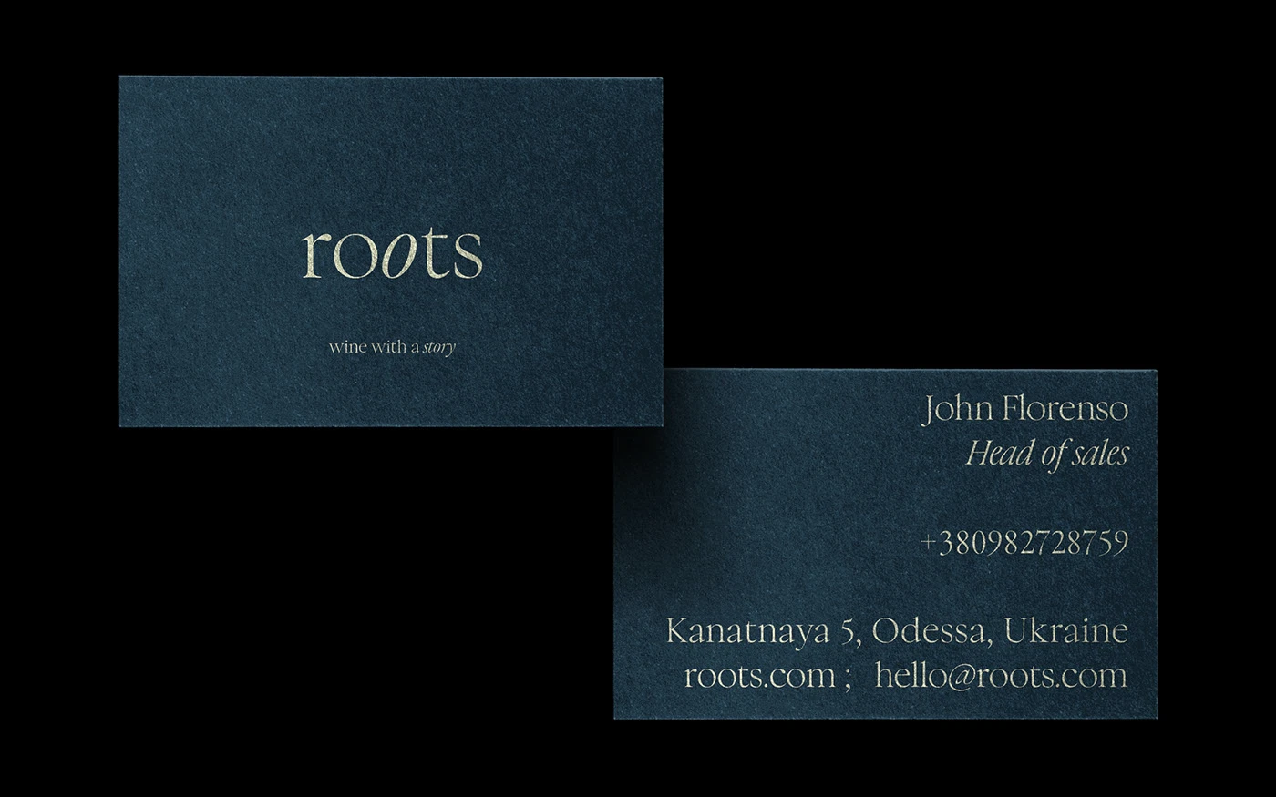 Front and back view of Roots wine brand business cards on textured slate blue paper, featuring the 'wine with a story' tagline and minimalist contact details for a Head of Sales in Odessa, Ukraine.