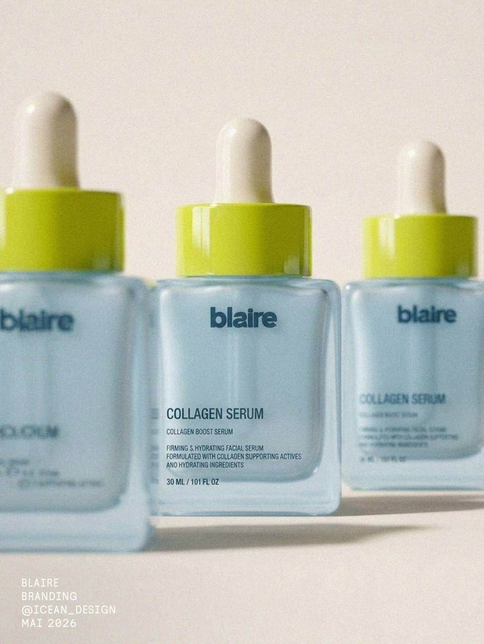 Close-up of three Blaire collagen serum bottles in frosted powder blue glass with citrus green caps and white droppers, using shallow focus to highlight the central bottle and label design.