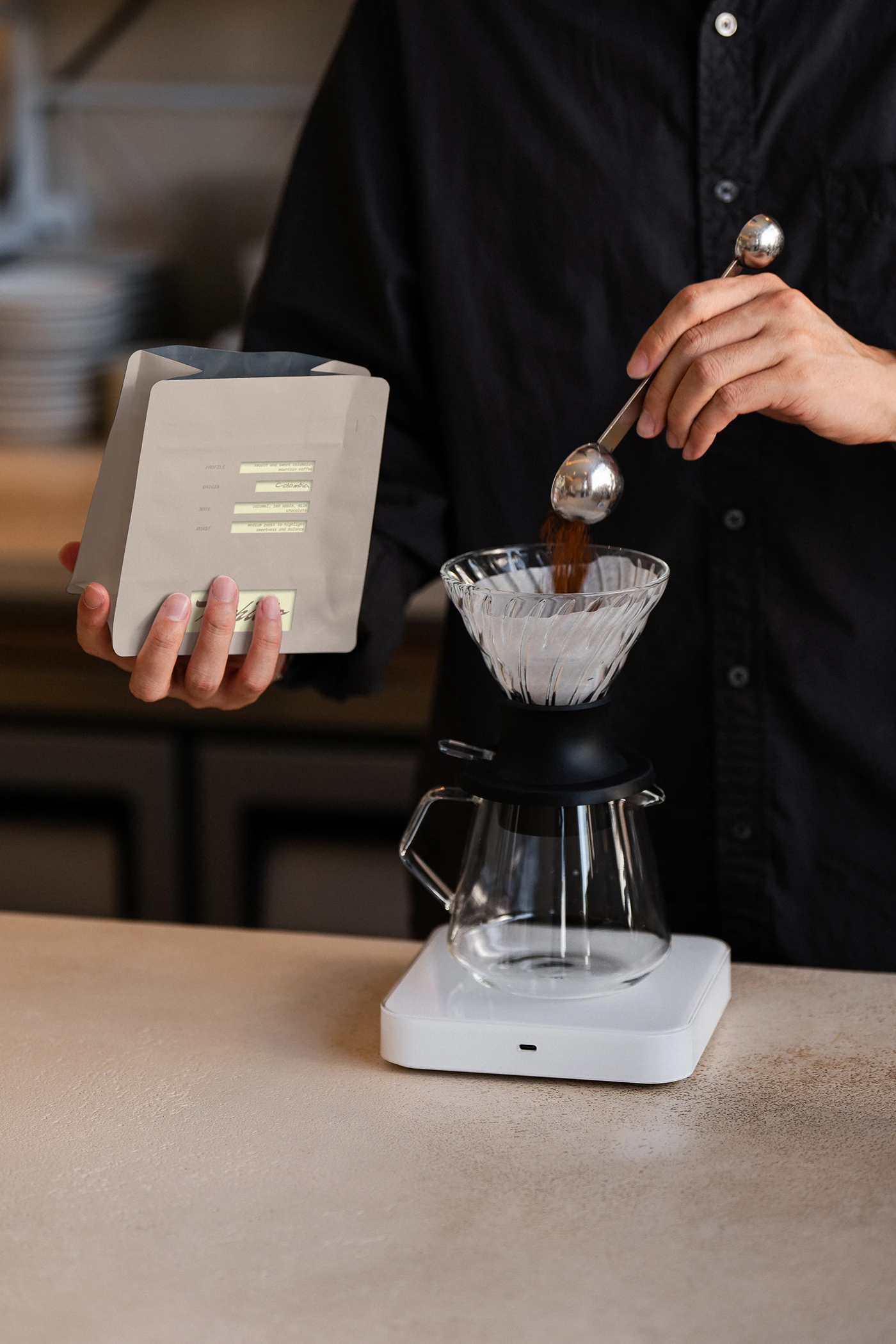 Archivio Coffee Cultura coffee brewing scene featuring barista preparing pour-over coffee with branded pouch and handwritten label accents.