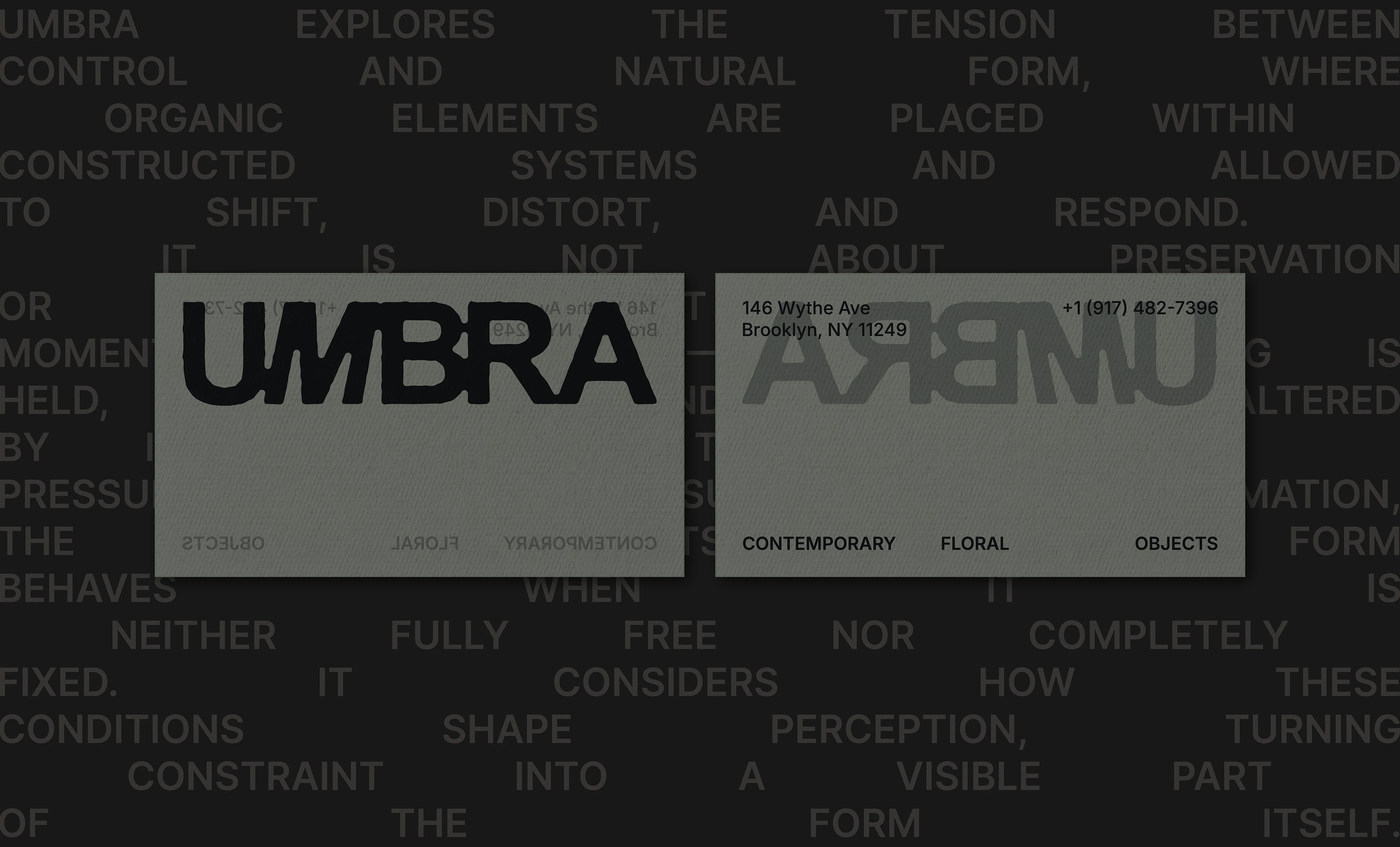 UMBRA business card design shown on a dark typographic background, featuring a bold black logo, reversed logo treatment, gray-green paper stock, and minimal brand details.