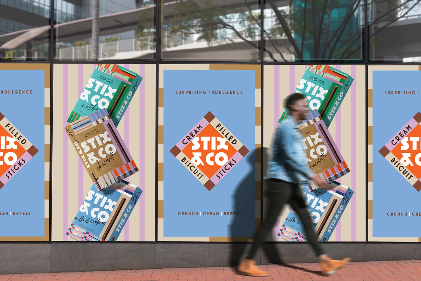 A series of large-scale outdoor posters for STIX & CO displayed on a modern glass building. The posters feature alternating designs of the diamond brand mark and dynamic, floating arrangements of the biscuit stick boxes against a background of repeating vertical lines, showing the impact of the modular system in a real-world retail environment.