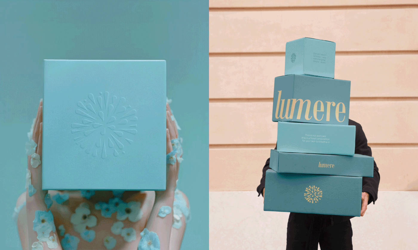 A side-by-side vertical composition. The left shows a model holding a square teal box in front of her face, featuring a large blind-embossed mandala logo. The right shows a person carrying a tall, precarious stack of Lumere packaging boxes in varying shades of teal and blue with large cream-colored serif branding.