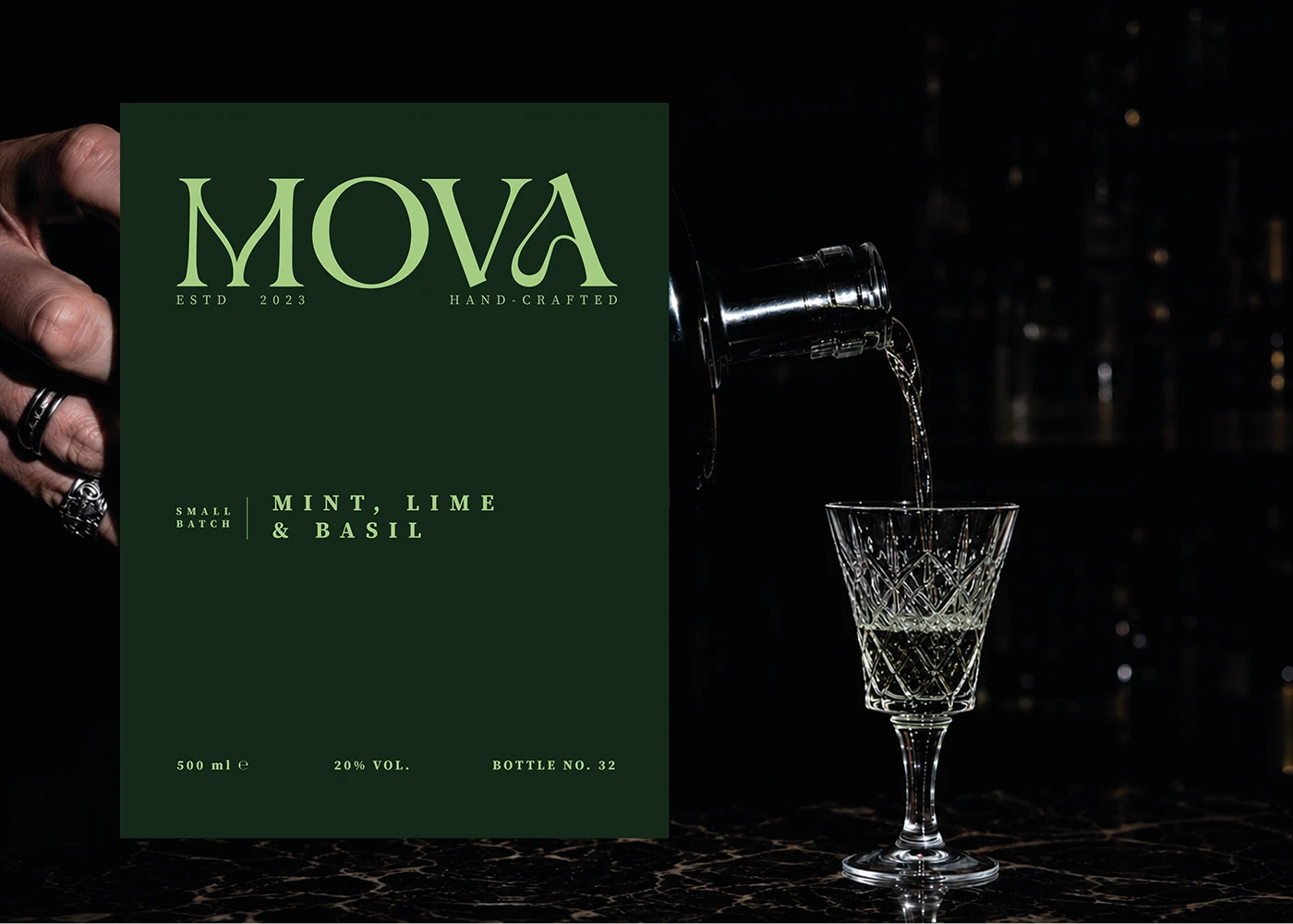 MOVA mint, lime and basil liqueur label beside a bottle pouring into a crystal glass.