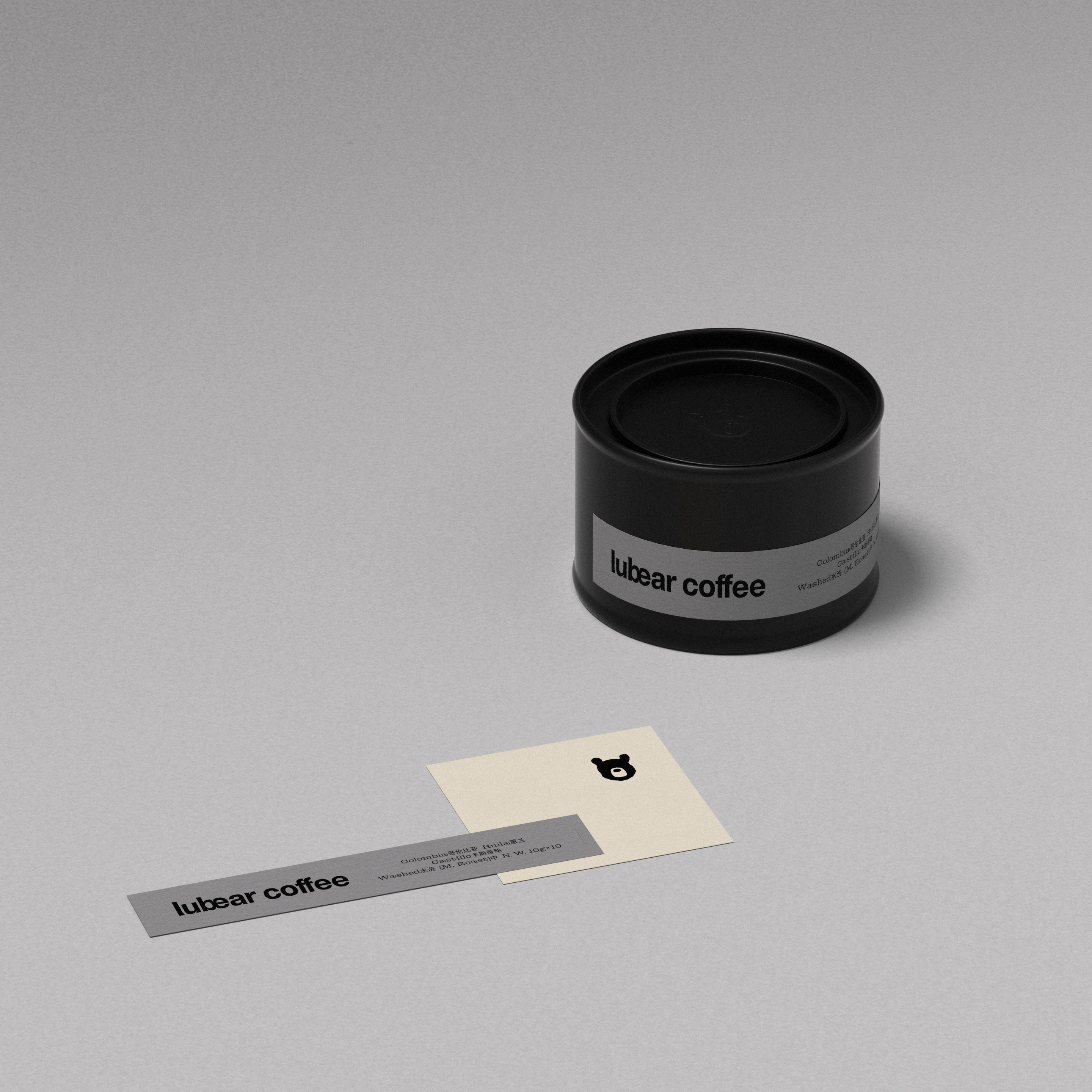 Lubear Coffee black product tin and printed brand labels with moon bear icon, showcasing the minimalist coffee packaging design and restrained identity system by taoSTUDIO.