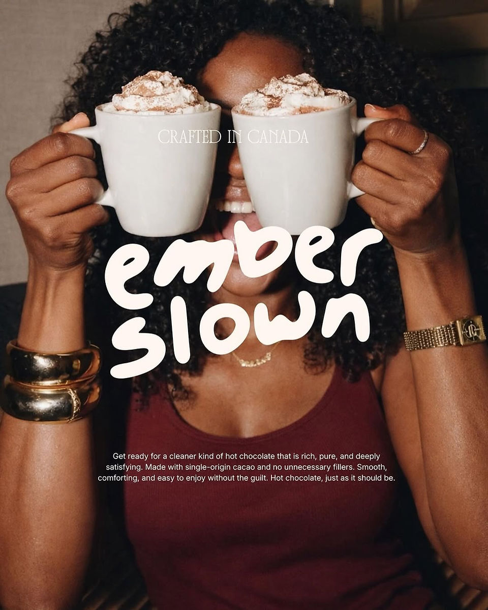 Woman holding two mugs of hot chocolate with whipped cream representing the Ember Slown café brand and warm chocolate lifestyle experience.