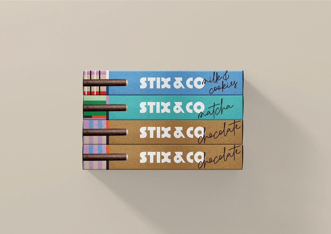 A flat-lay, top-down view of four STIX & CO biscuit boxes stacked vertically. The stack includes one "milk & cookies" blue box, one "matcha" green box, and two "chocolate" brown boxes. This composition highlights how the rhythmic geometric patterns and the prominent logo create a unified brand language when the product is displayed in bulk.