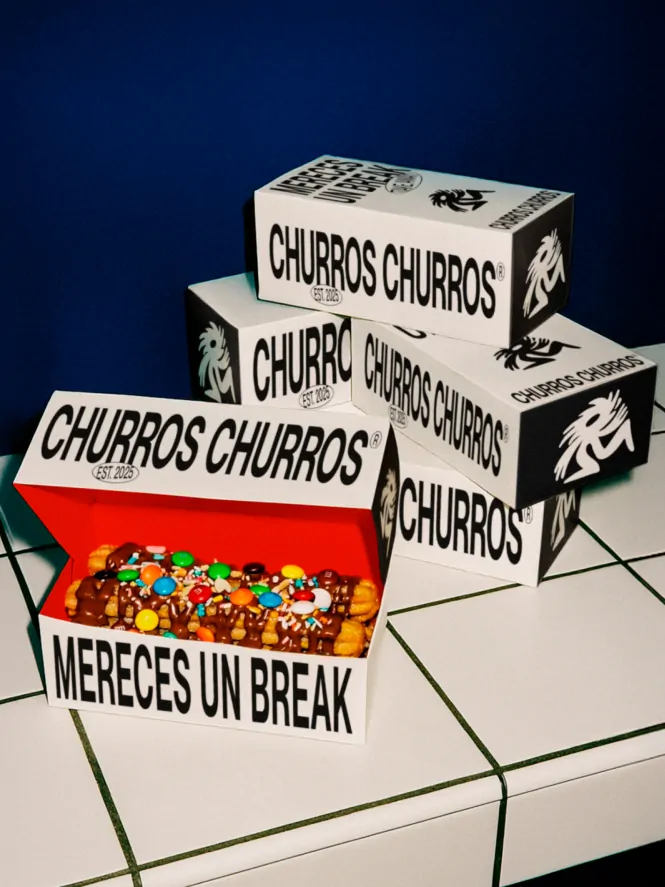 Churros Churros packaging design featuring stacked takeaway boxes and an open churros box filled with chocolate drizzle and colorful toppings.