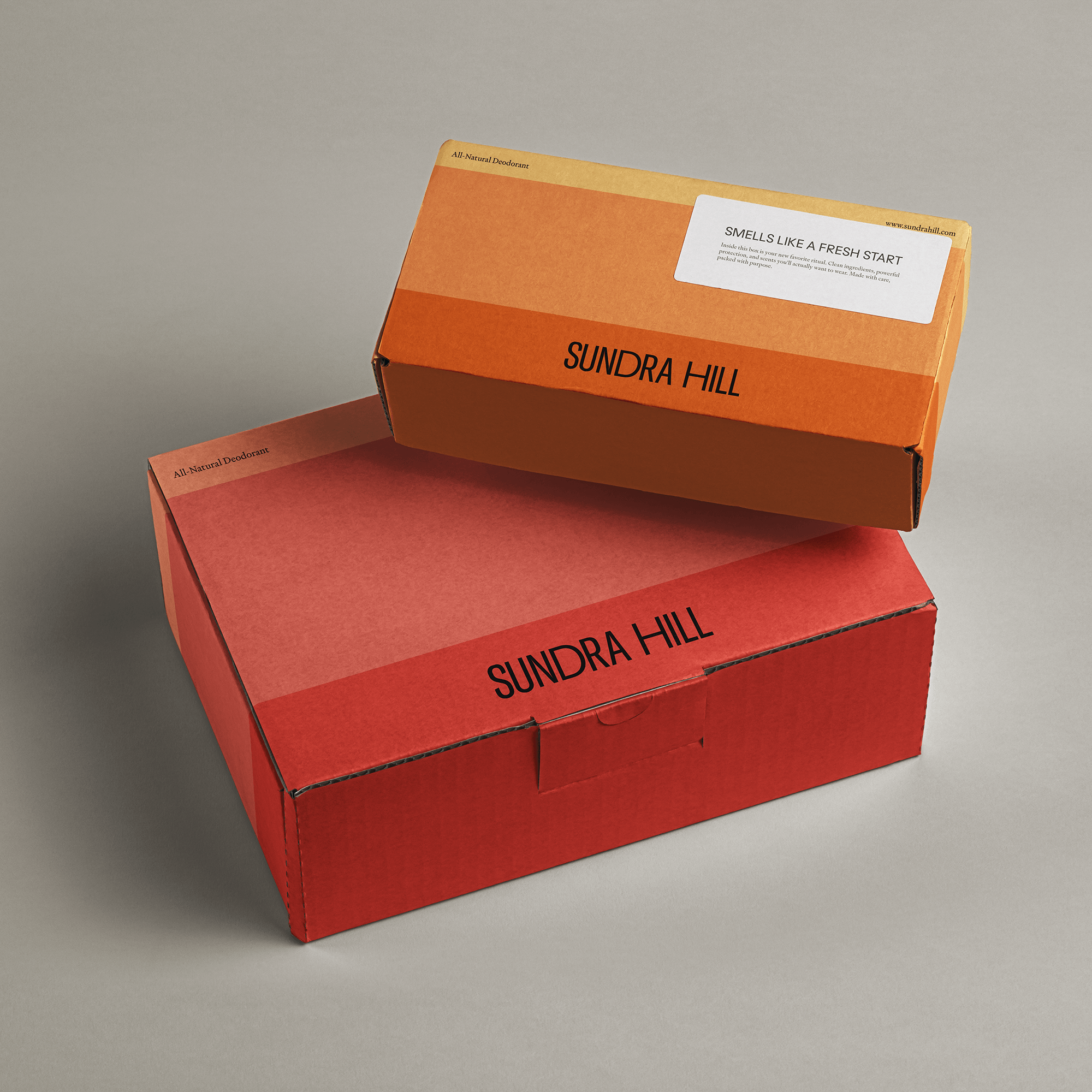 Sundra Hill shipping boxes in gradient orange and red tones with minimalist typography, highlighting sustainable packaging design and premium brand presentation.