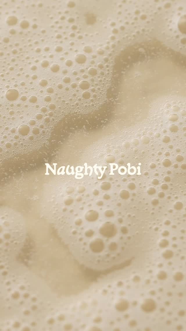 Close-up of shampoo foam with Naughty Pobi branding, highlighting sensory-driven pet care packaging influenced by human beauty and skincare aesthetics.