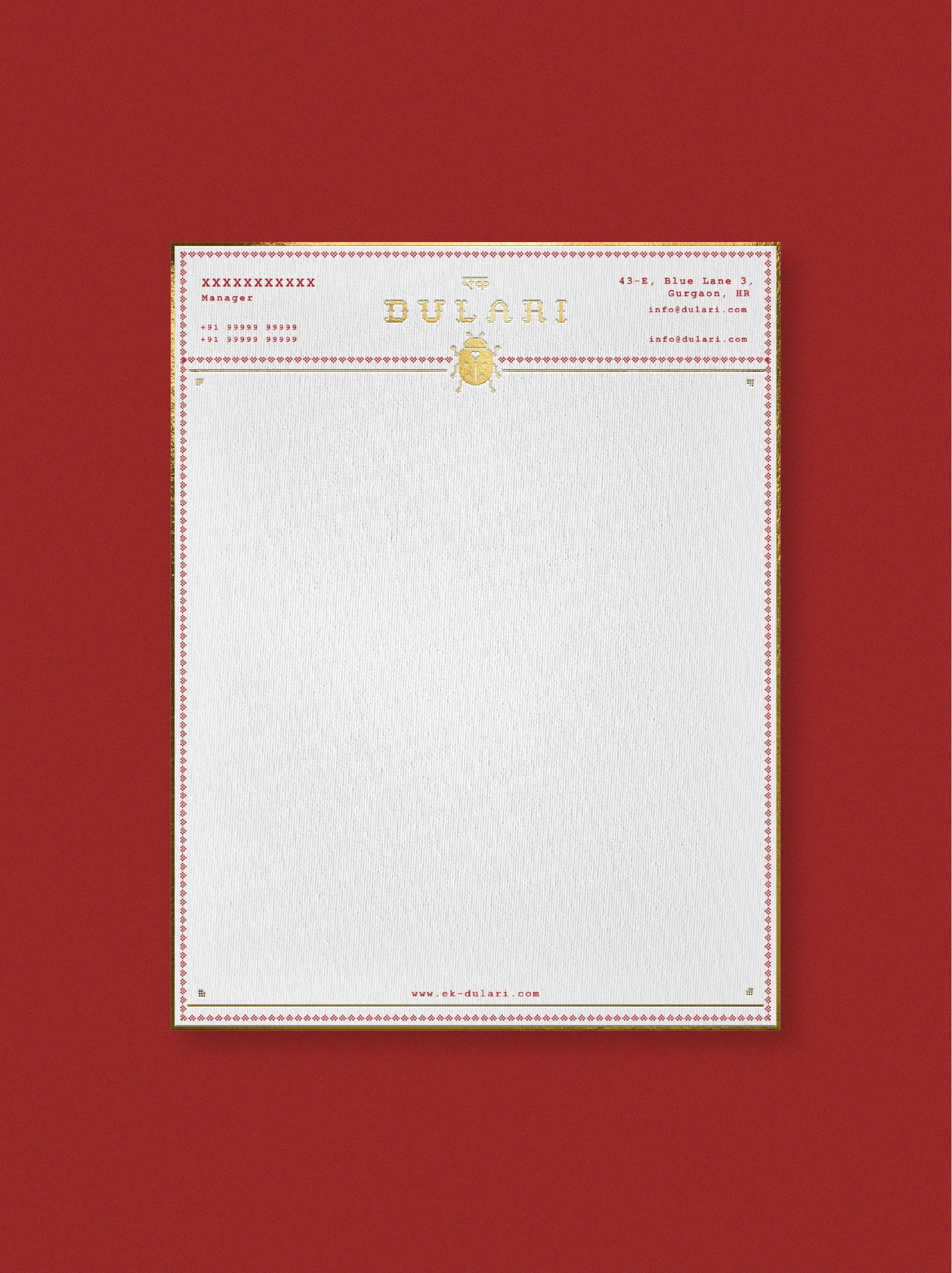 Dulari fashion brand identity stationery design with embroidered border pattern, ladybug emblem, and structured typography on textured paper stock.